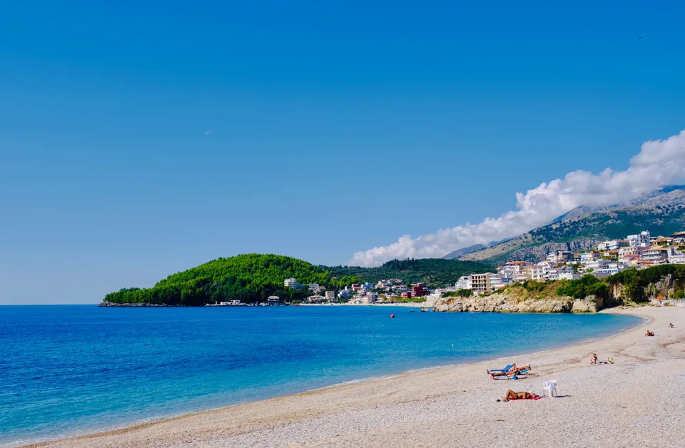 The beach at Himarë with the town on the hillside