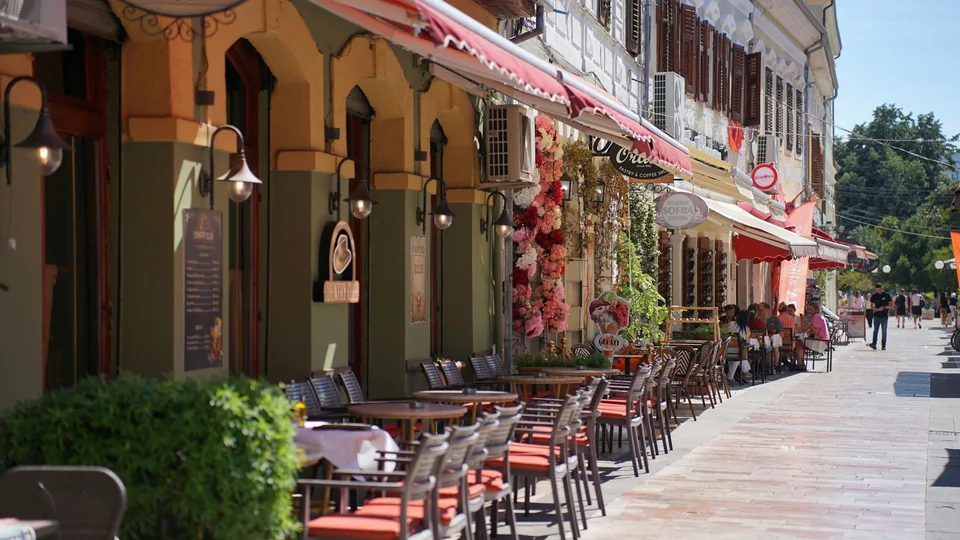 Cafés with outdoor tables along a pedestrian street in Shkodër