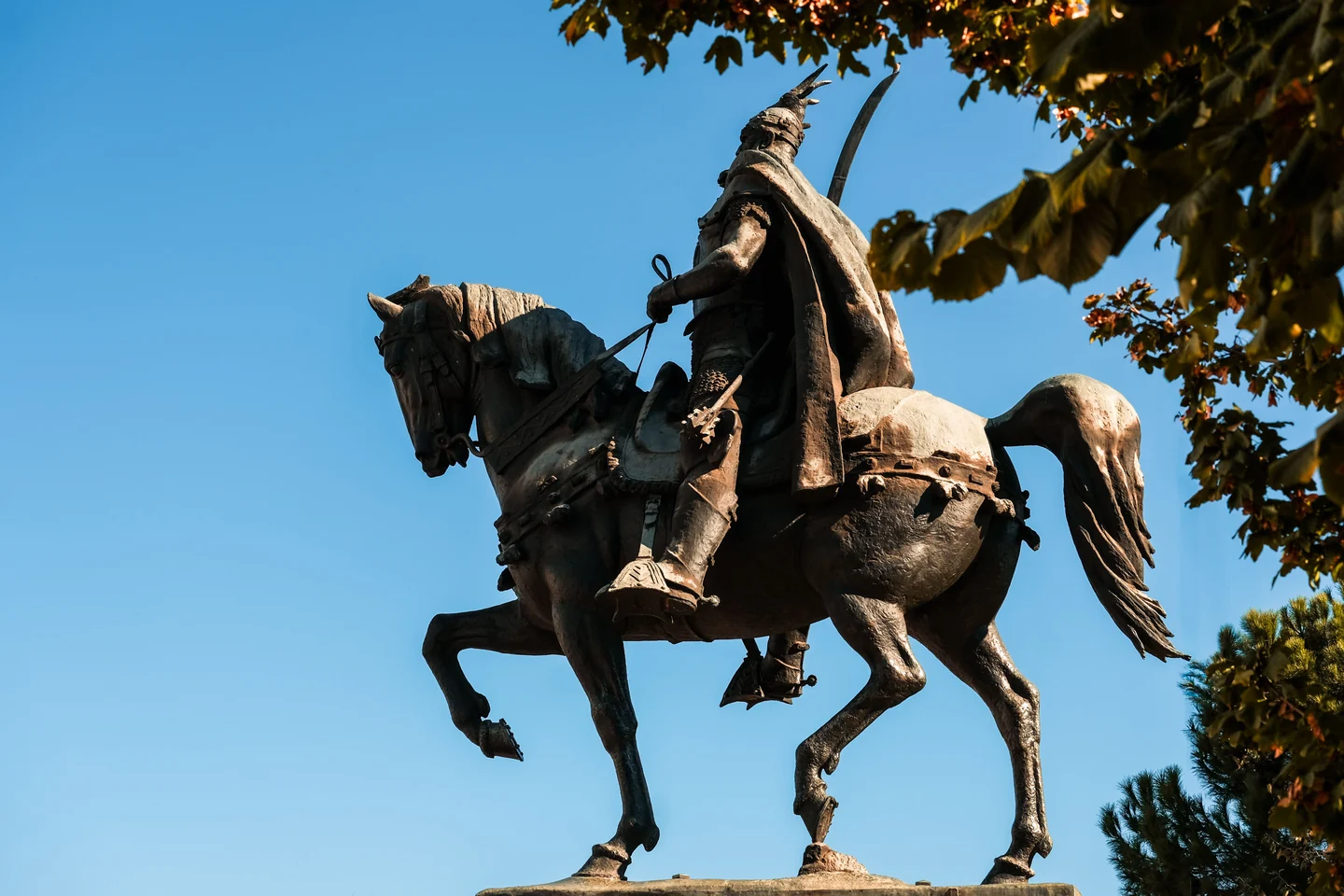 Skanderbeg statue among autumn trees in Tirana